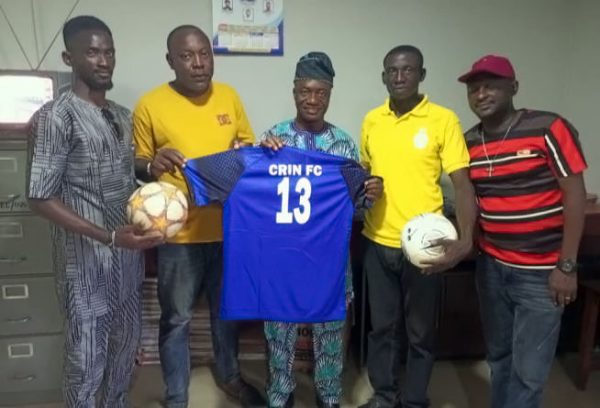 The Chairman, Sports Committee, Mr. Onatunde- Onanuga (middle) displaying the jersey